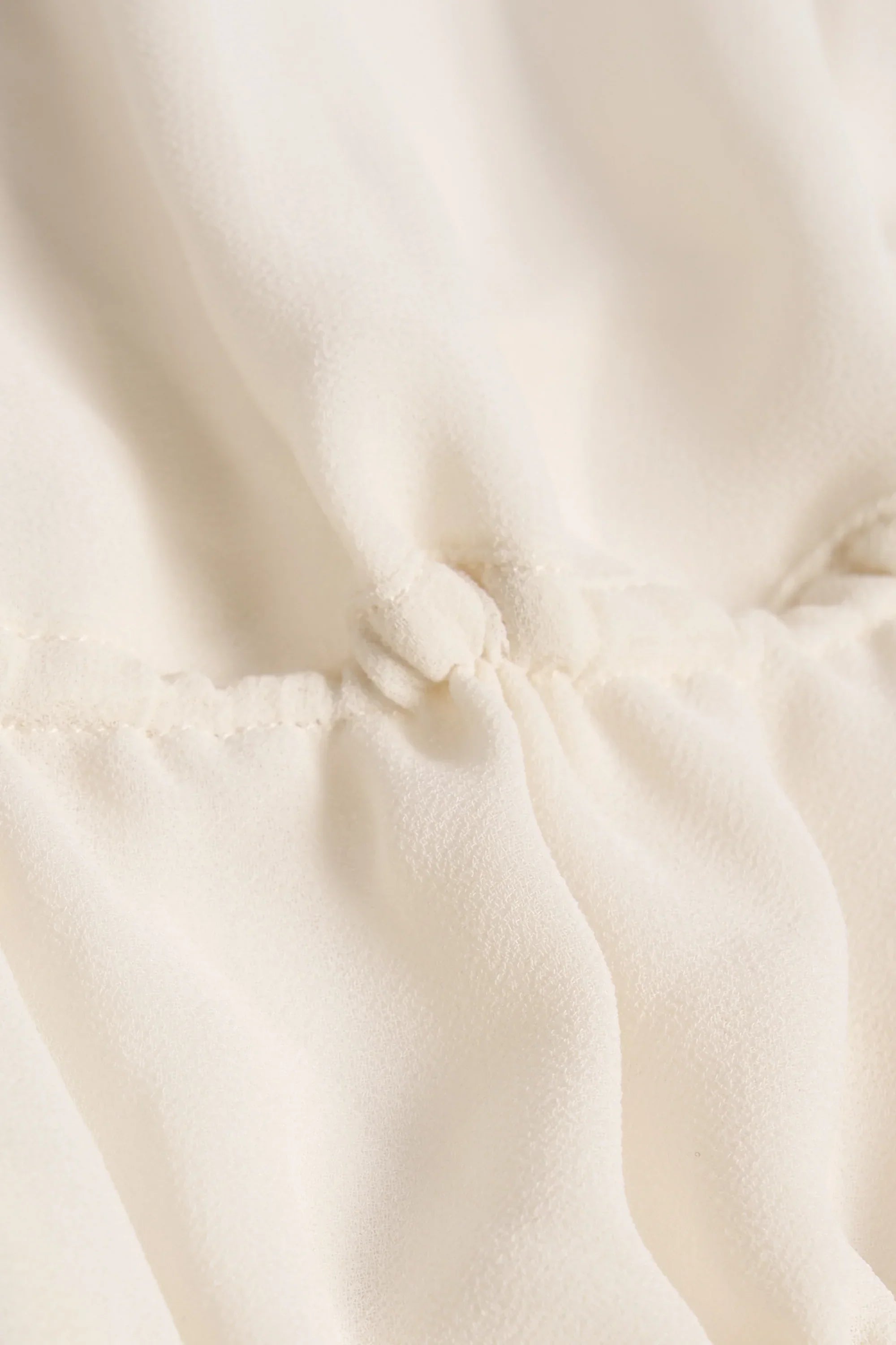 Cut-Out Semi-Sheer Ruched Halterneck Crop Top in Ivory